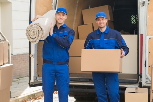 Removal team handling boxes during a flat move in Holland Park