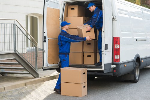 Professional movers loading items for a Holland Park home or office move