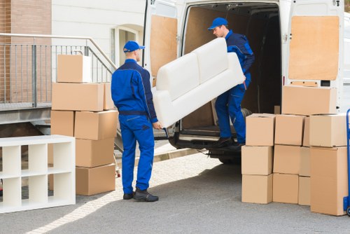 A removals team planning a home move near Holland Park apartment buildings