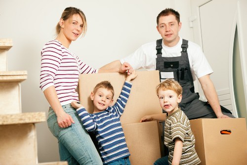 Moving professionals handling office furniture carefully