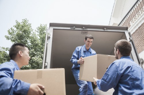 Moving boxes and household items being loaded for a Holland Park relocation