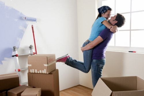 Careful unloading of boxes and furniture at a Holland Park address