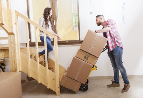 Loading furniture into a van for a Holland Park house move