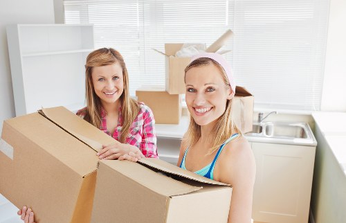 Packed household boxes and furniture prepared for a local move in Holland Park